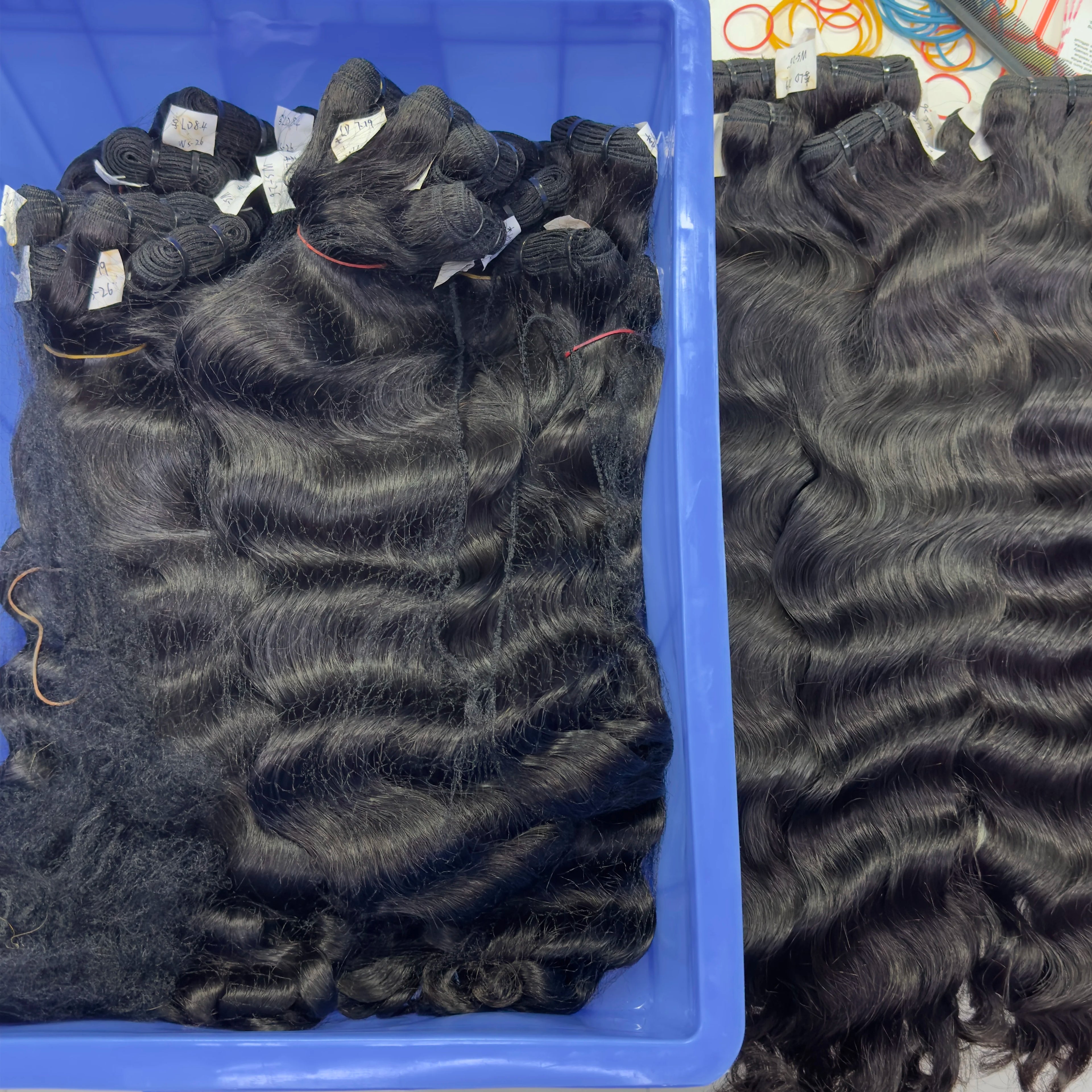 Raw Virgin Human Hair Bundles displayed in a blue container, showcasing natural waves and quality styling options.