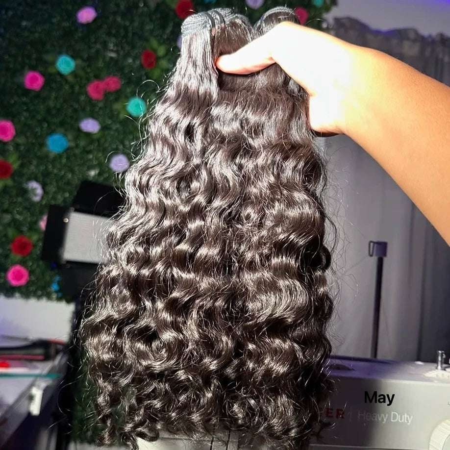 Raw Virgin Human Hair Bundles held in hand, showcasing natural waves and luxurious texture.